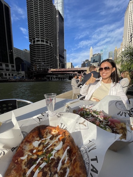 Girl posing with food by the river